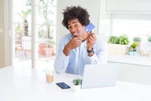 bigstock-African-American-man-using-lap-293273896