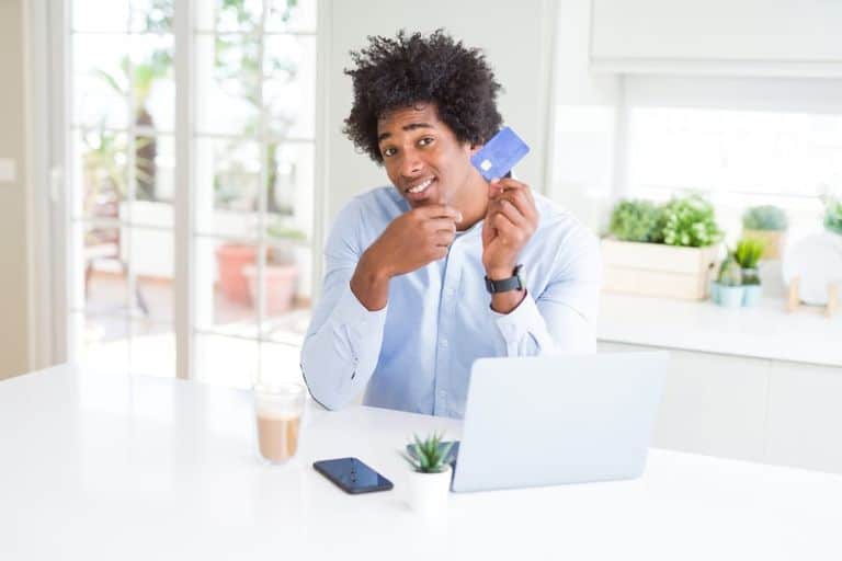 bigstock-African-American-man-using-lap-293273896