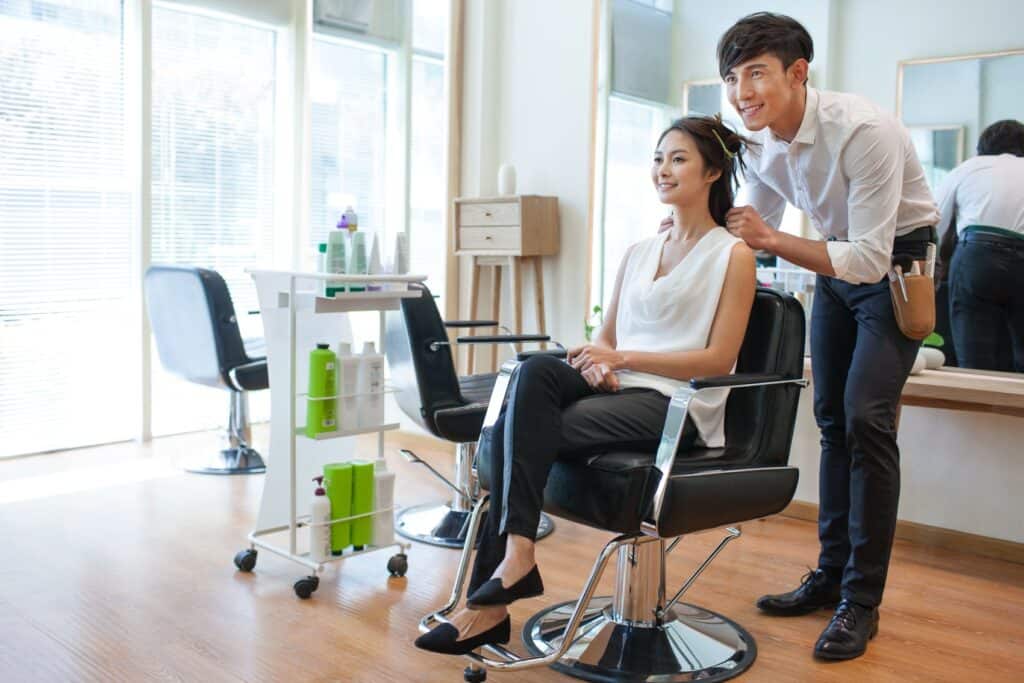 hairdresser in salon working on client