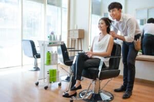 hairdresser in salon working on client