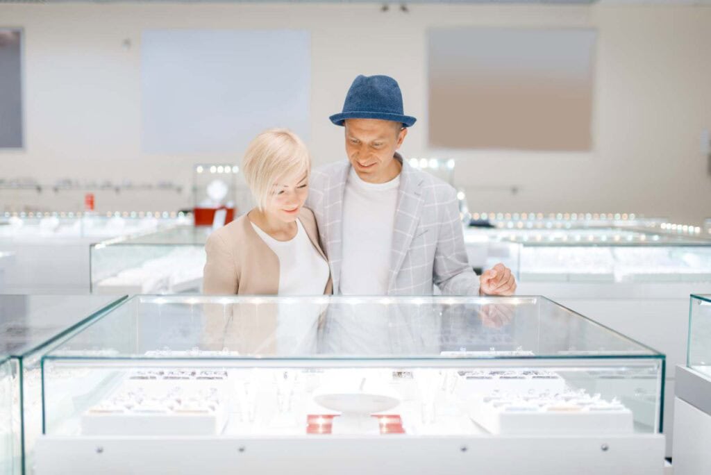 Love couple looking on jewels in jewelry store